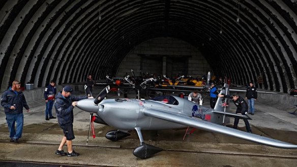 Technical Manager Wade Hammond of South Africa pulls out the airplane of Hannes Arch of Austria from the hangar during the fourth stage of the Red Bull Air Race World Championship in Tokol, Hungary on July 17, 2016.